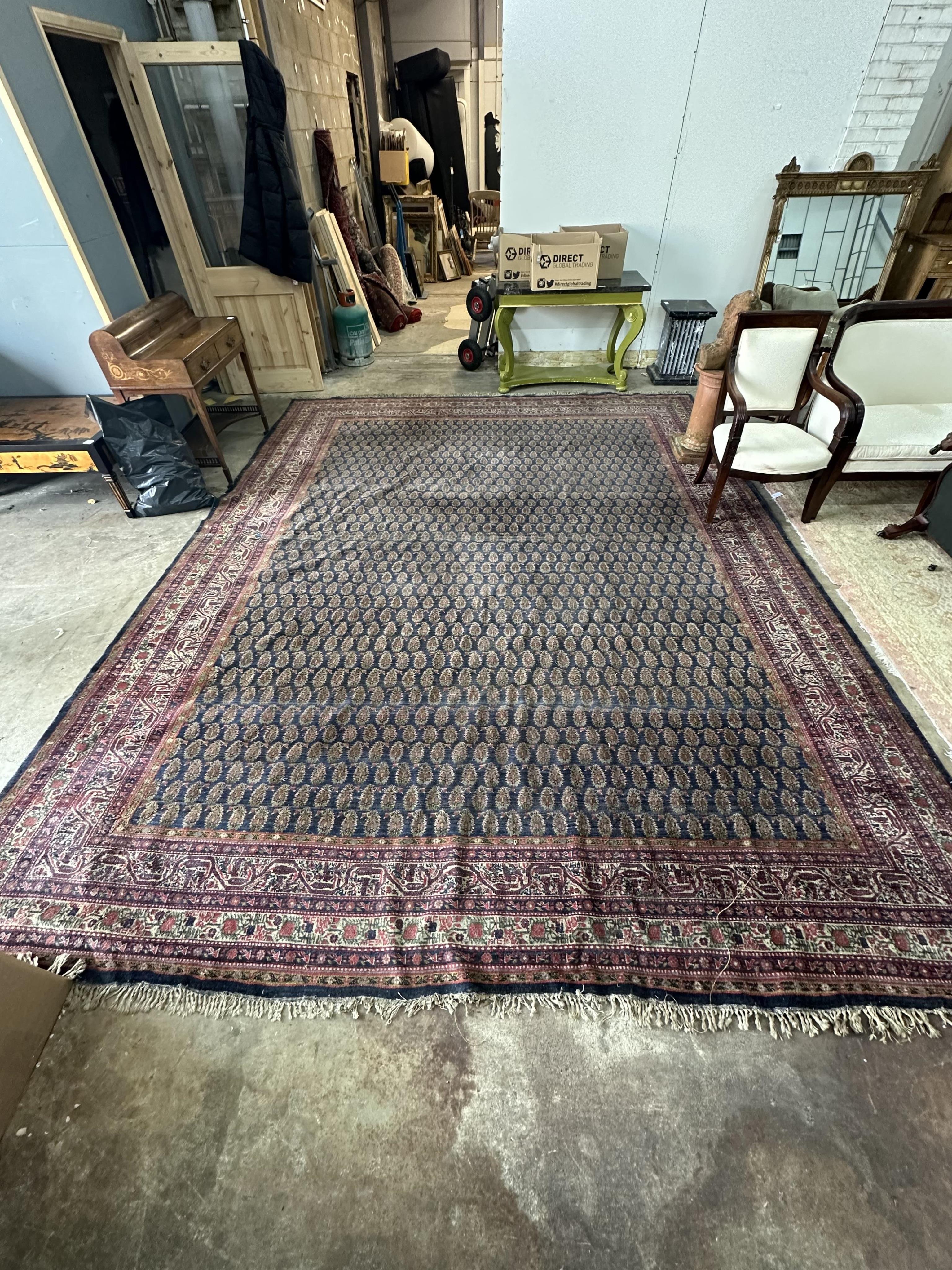 A Serabend blue ground boteh carpet, approximately 406 x 334cm. Condition - poor